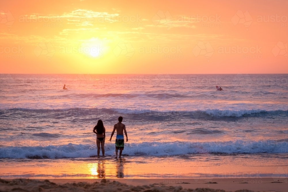 Couple in the water at sunrise - Australian Stock Image