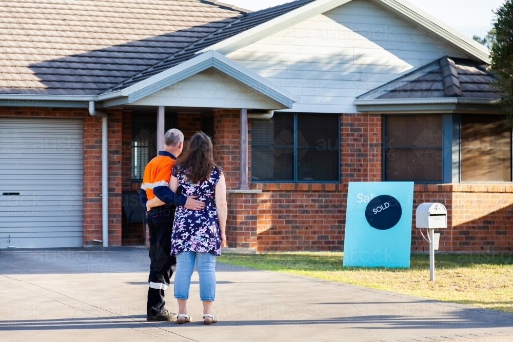 Couple looking at sold home property - Australian Stock Image