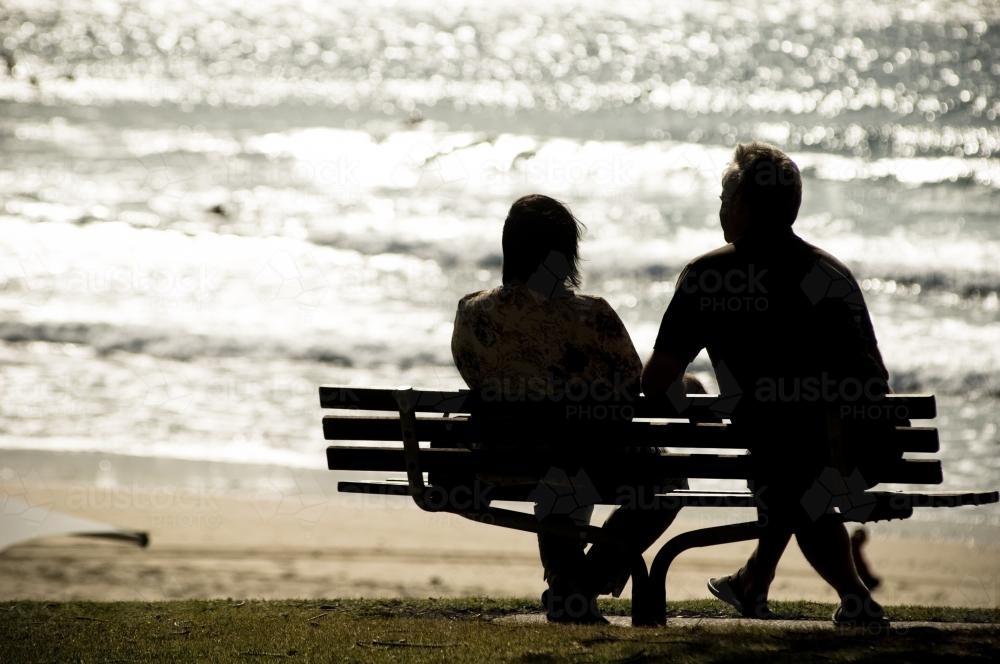 Couple relax on chair at the beach - Australian Stock Image