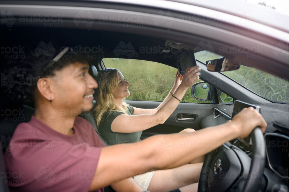 Couple sitting together in a car driving - Australian Stock Image