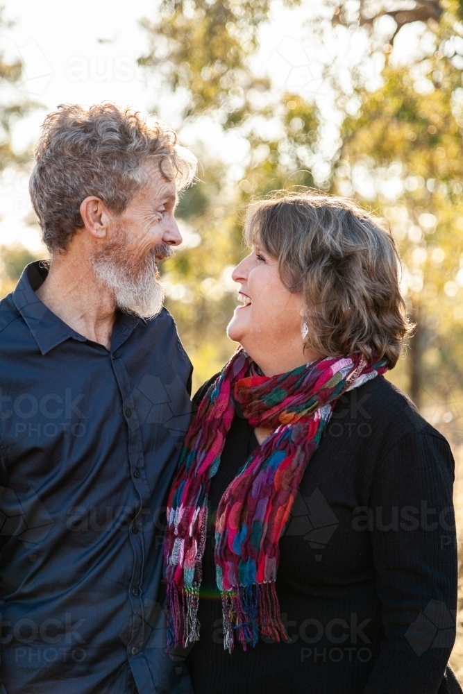 Couple standing together looking at each other - Australian Stock Image