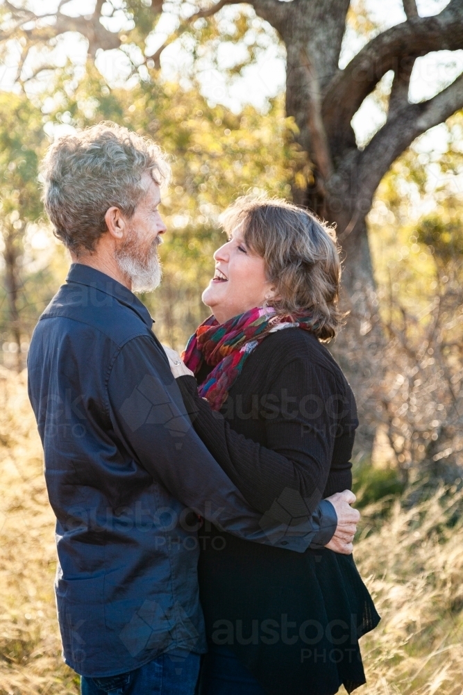 Couple standing together looking at each other - Australian Stock Image