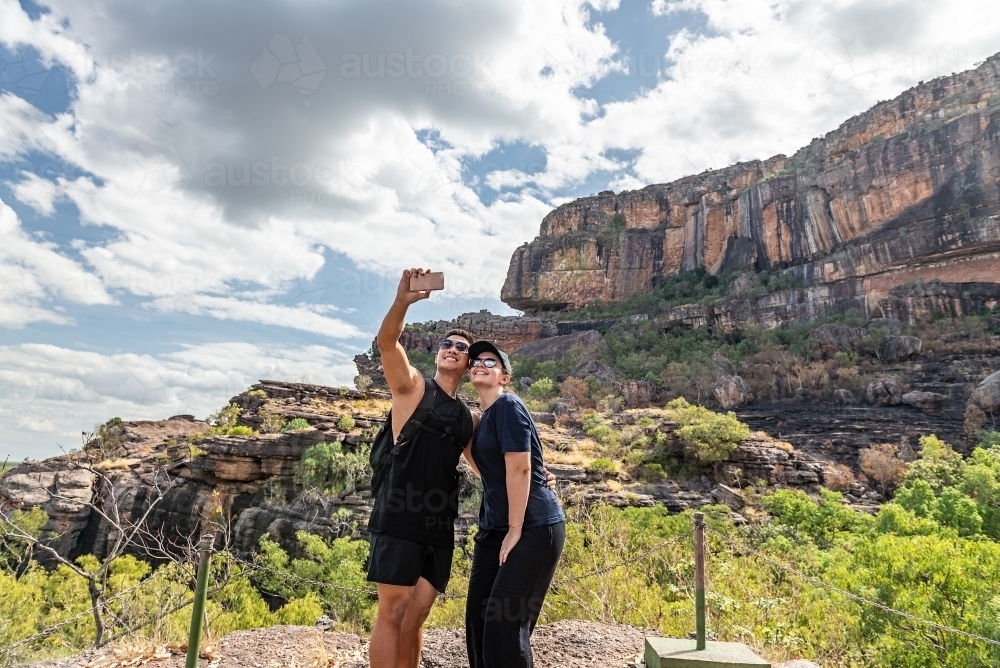 Couple taking selfies at Nourlangie, Kakadu - Australian Stock Image