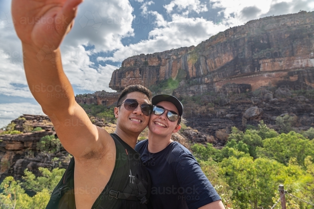 Couple taking selfies at Nourlangie, Kakadu - Australian Stock Image