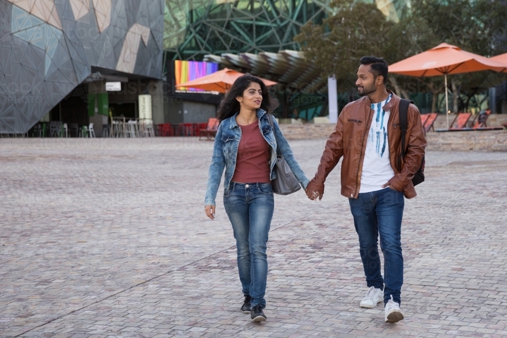 Couple Walking in Federation Square - Australian Stock Image