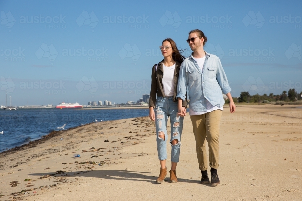Couple Walking on Beach at South Melbourne - Australian Stock Image