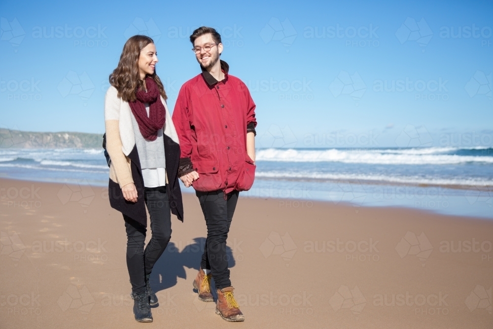 Couple Walking on the Beach in Winter - Australian Stock Image