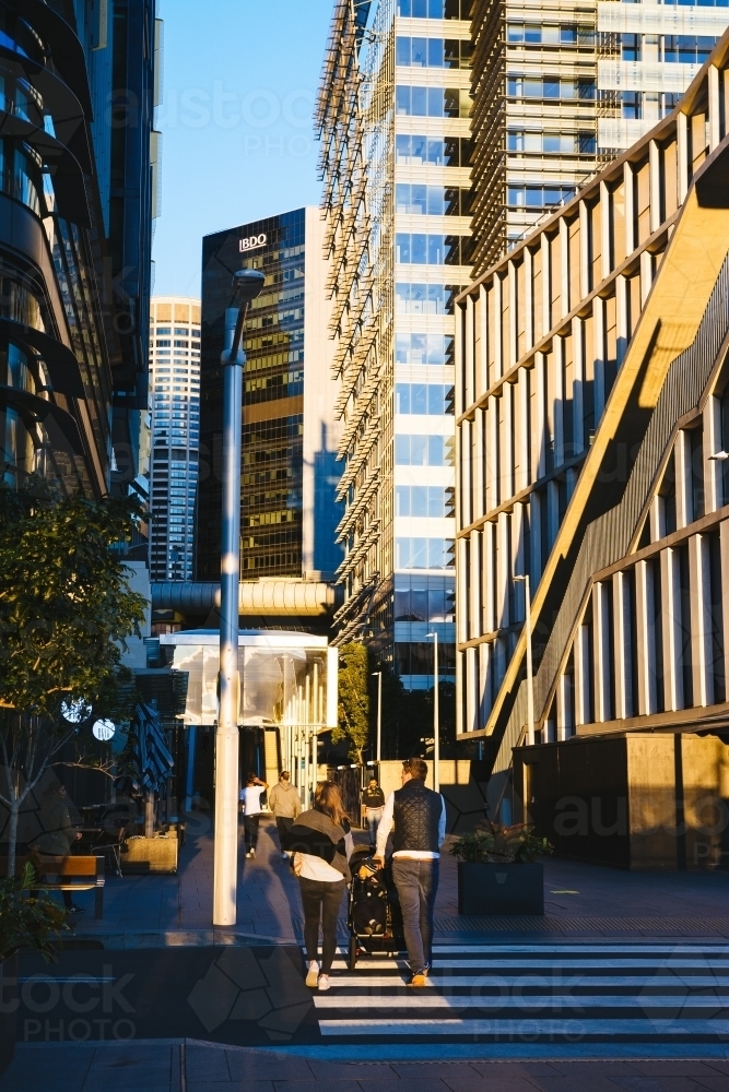 Couple walking with pram around the city - Australian Stock Image