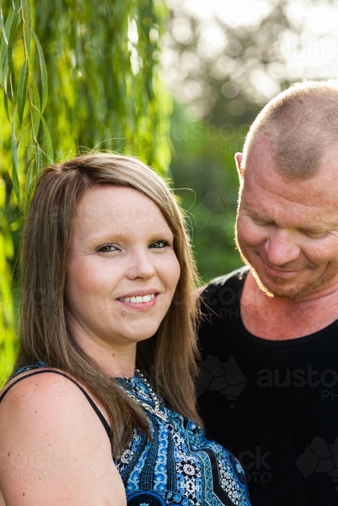 Couple with woman looking at camera smiling - Australian Stock Image