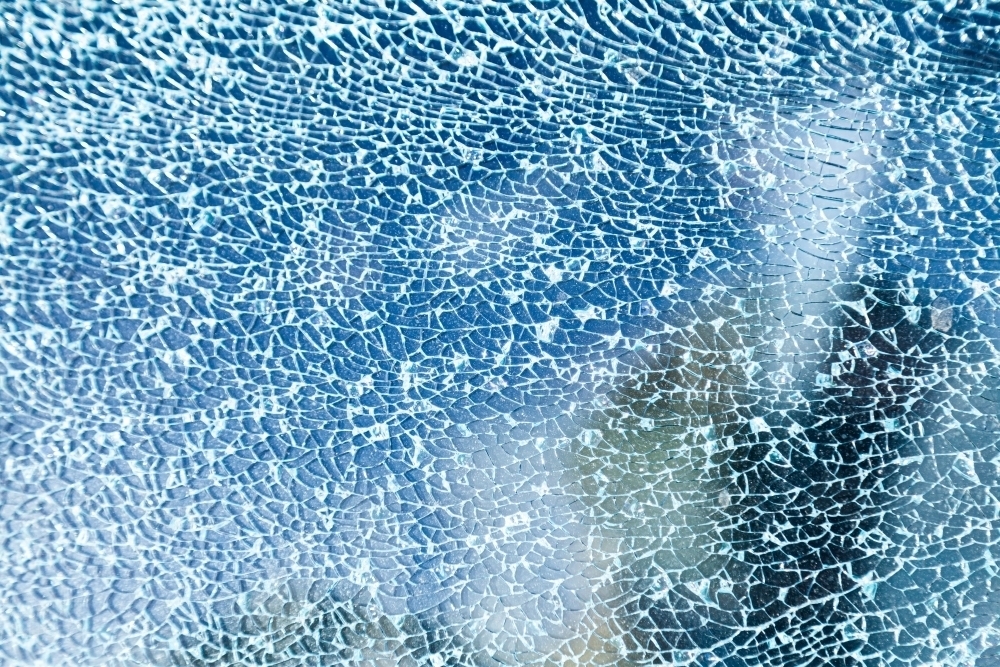 Cracks in glass of shattered car window - Australian Stock Image