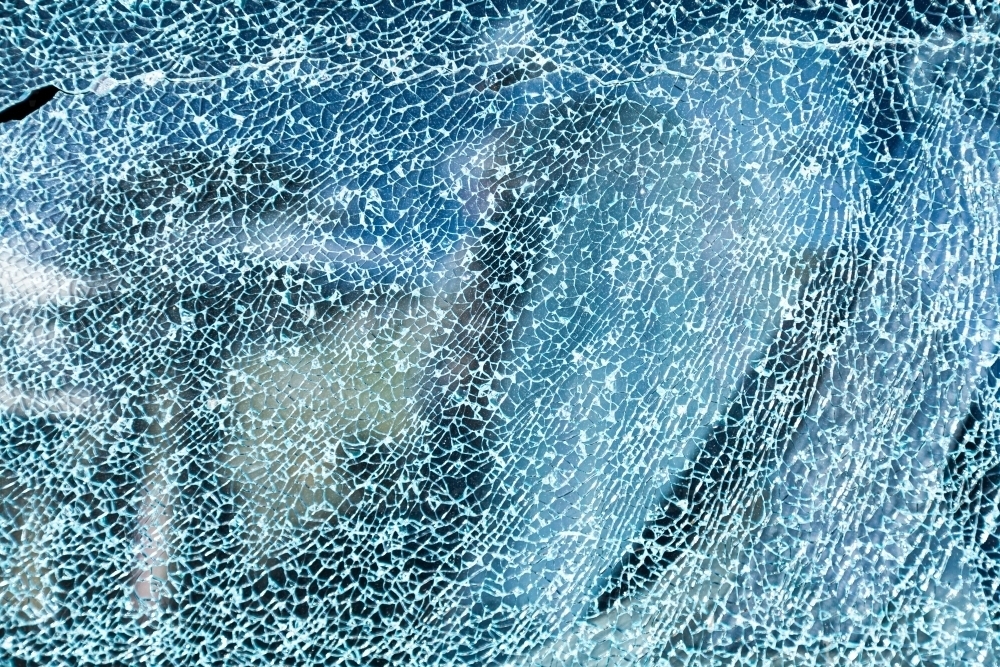 Cracks in glass of shattered car window - Australian Stock Image