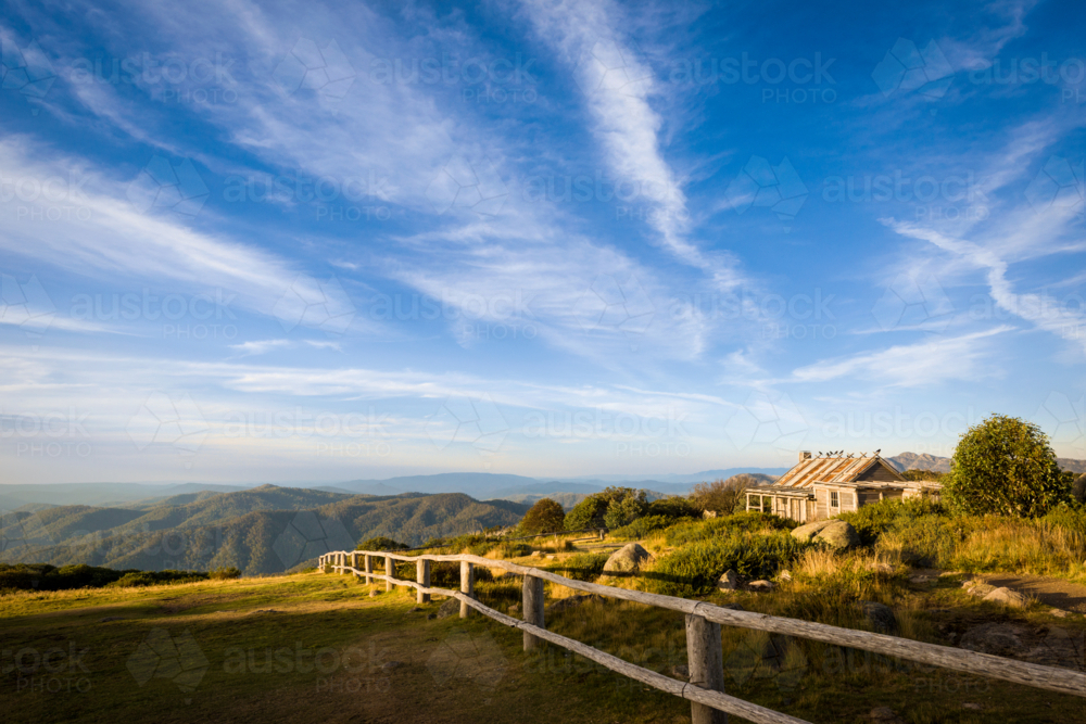 Craig's Hut on hilltop in sunlight - Australian Stock Image