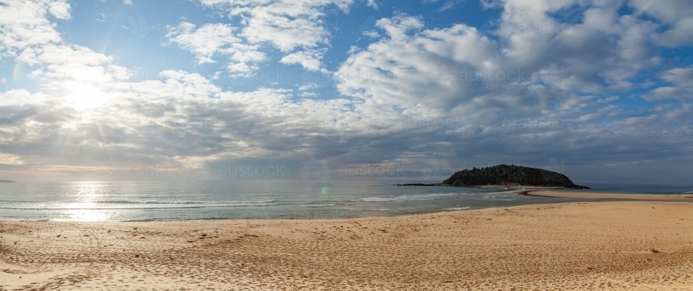 Crampton island on the coast with the sunrise over the sea - Australian Stock Image