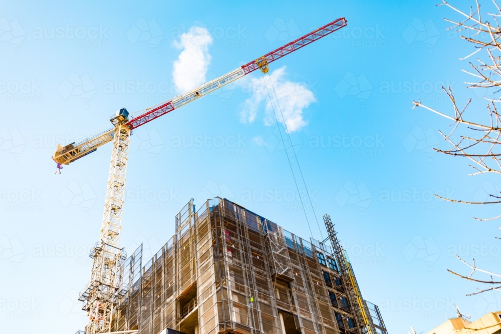Crane working atop building under construction in Adelaide CBD - Australian Stock Image
