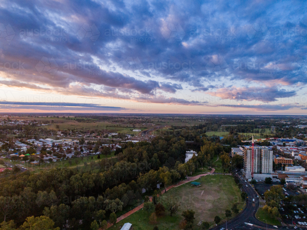 crane working on construction of high rise building in the city of Dubbo at sunset - Australian Stock Image