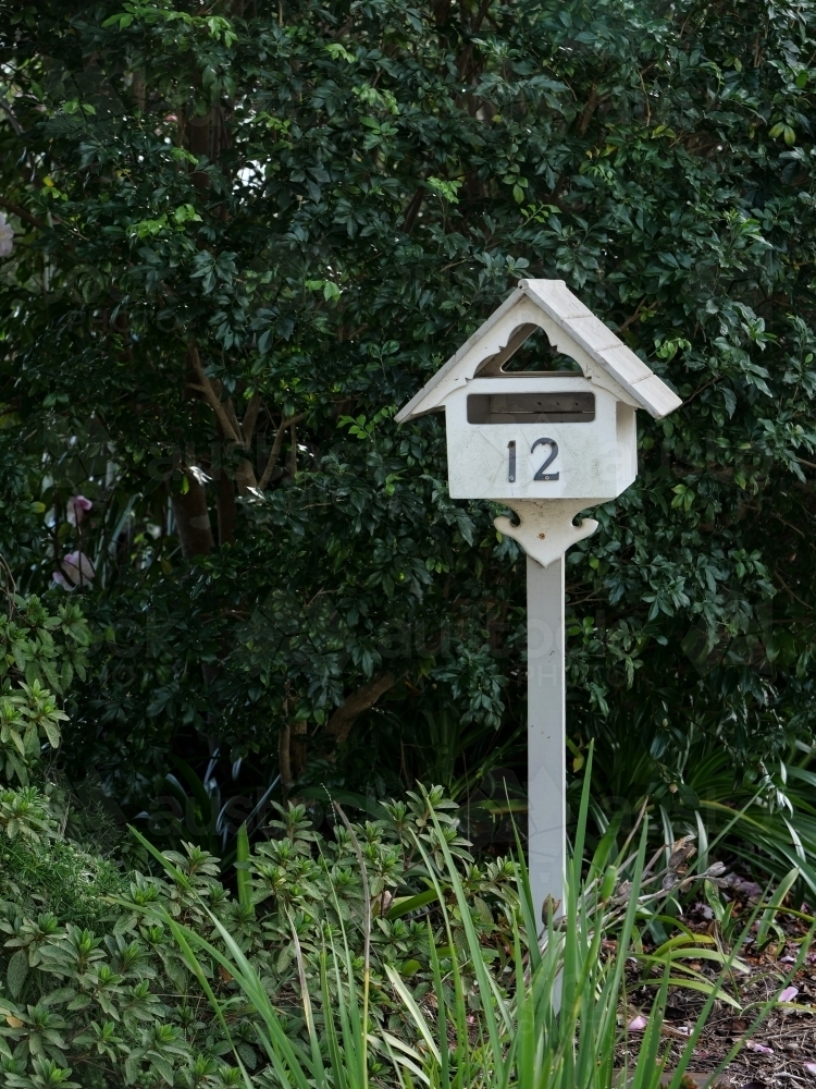 Cream metal letterbox for #12 - Australian Stock Image