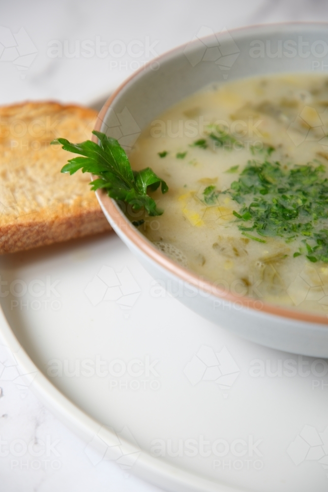 Cream of mushroom soup with a slice of toasted bread. - Australian Stock Image