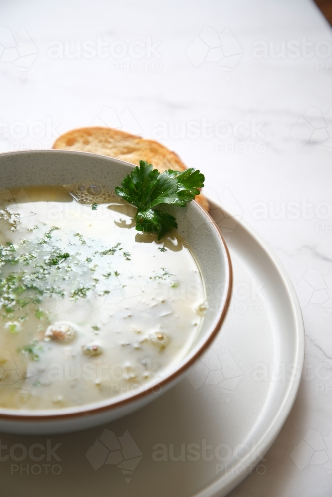 Cream of mushroom soup with a slice of toasted bread. - Australian Stock Image