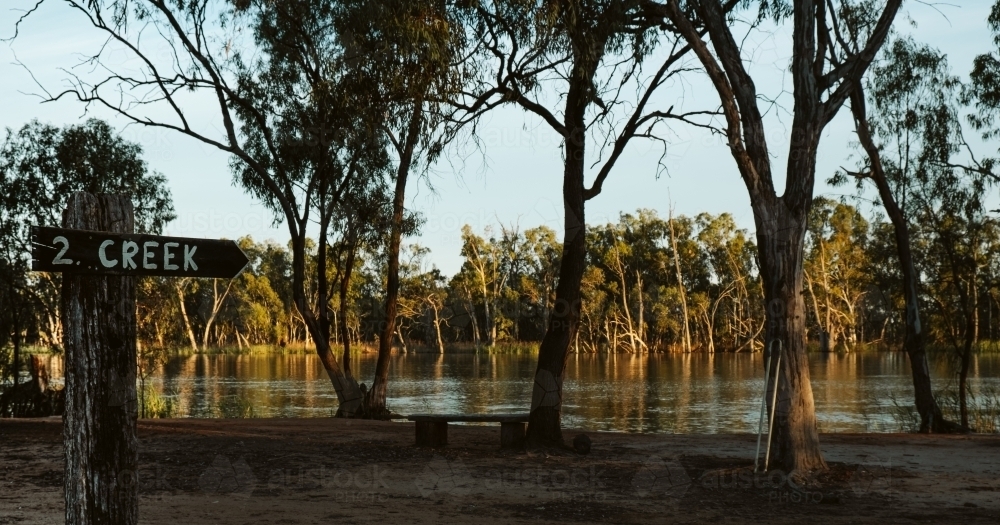 Creek Sign post showing the River Murray in the morning light - Australian Stock Image