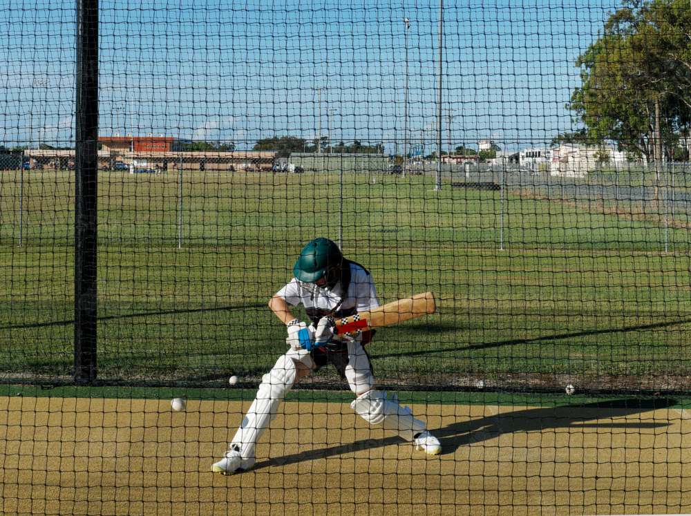 Cricket training and practice in the nets for left handed female cricket player - Australian Stock Image