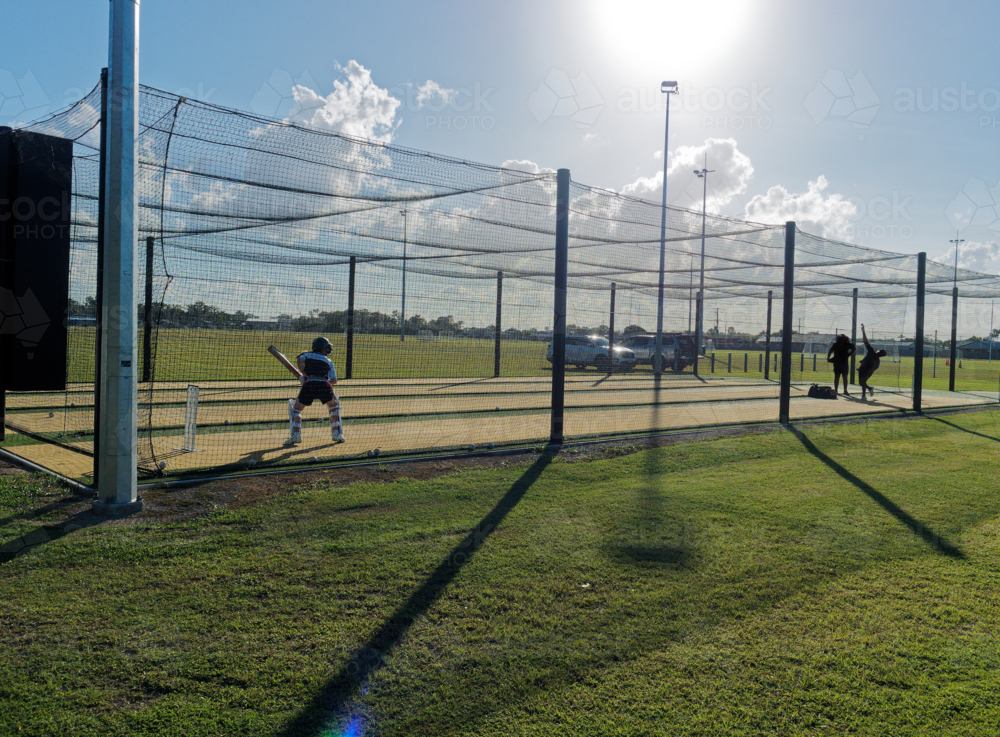 Cricket training and practice in the nets for left handed female cricket player - Australian Stock Image