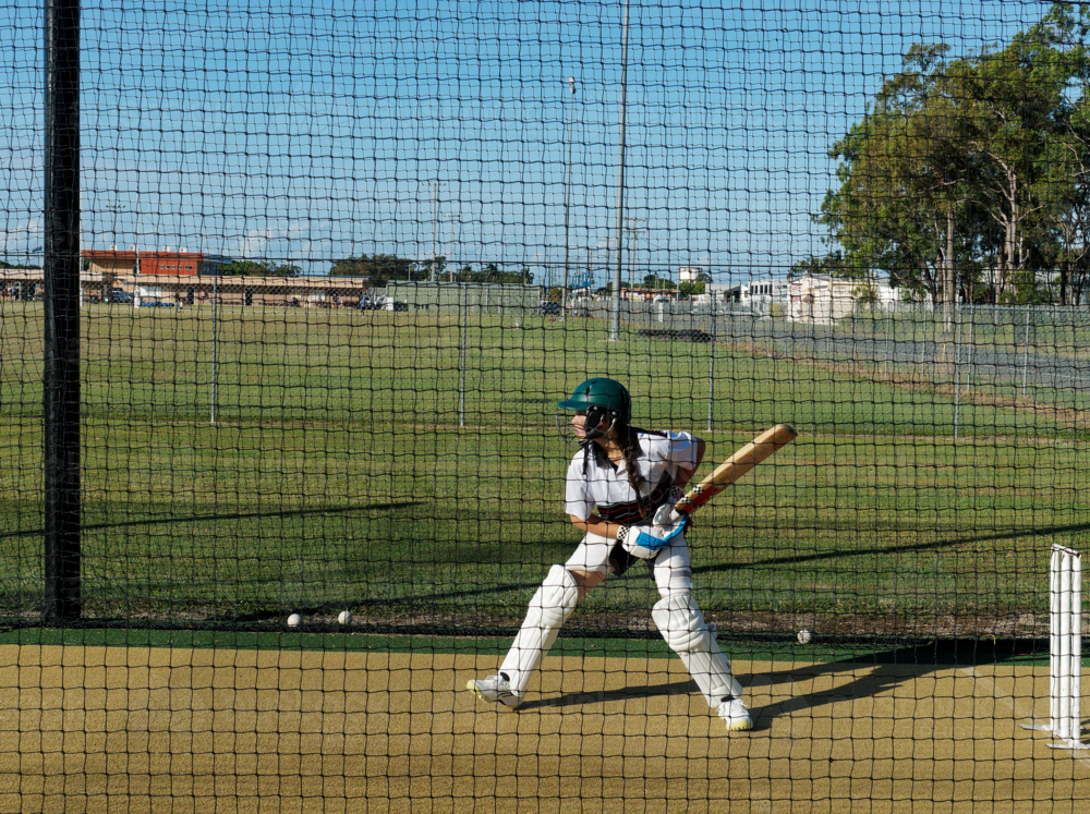 Cricket training and practice in the nets for left handed female cricket player - Australian Stock Image