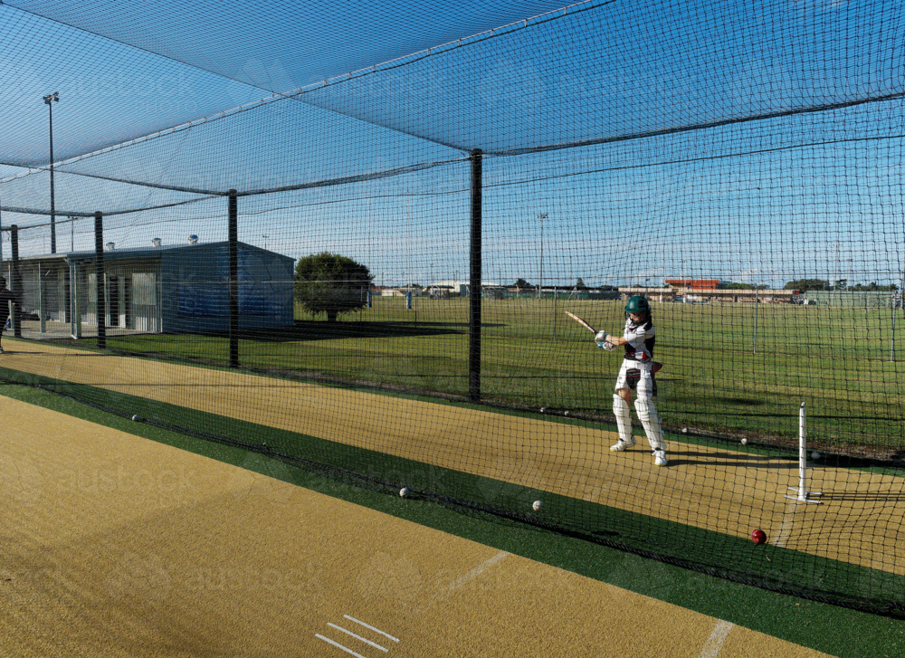 Cricket training and practice in the nets for left handed female cricket player - Australian Stock Image