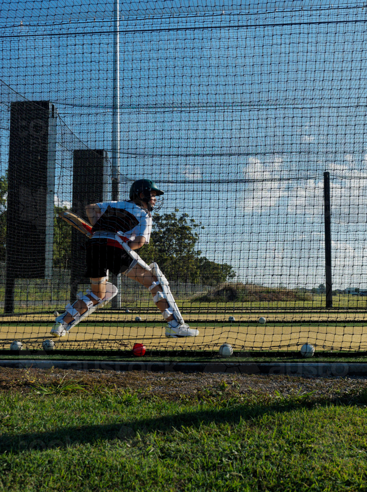 Cricket training and practice in the nets for teen left handed female cricket player - Australian Stock Image
