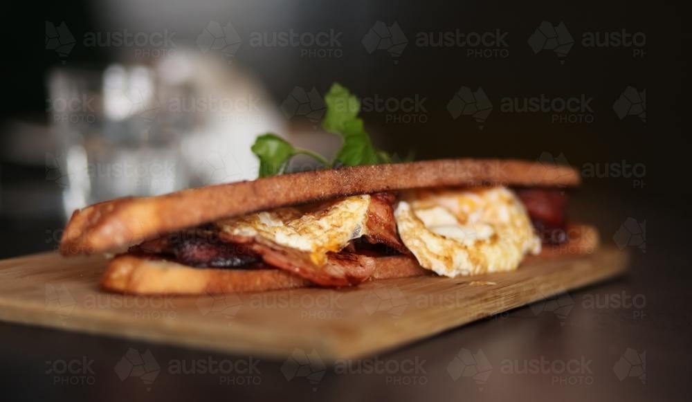 Crispy bacon and egg sandwich for breakfast - Australian Stock Image