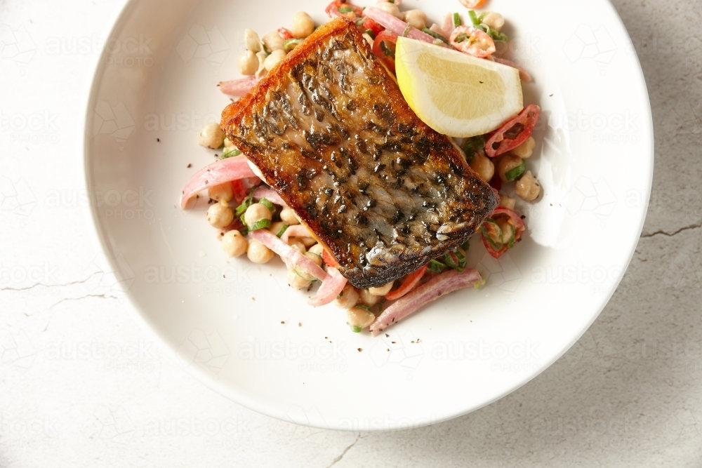 Crispy skin Barramundi with chick pea salad - Australian Stock Image