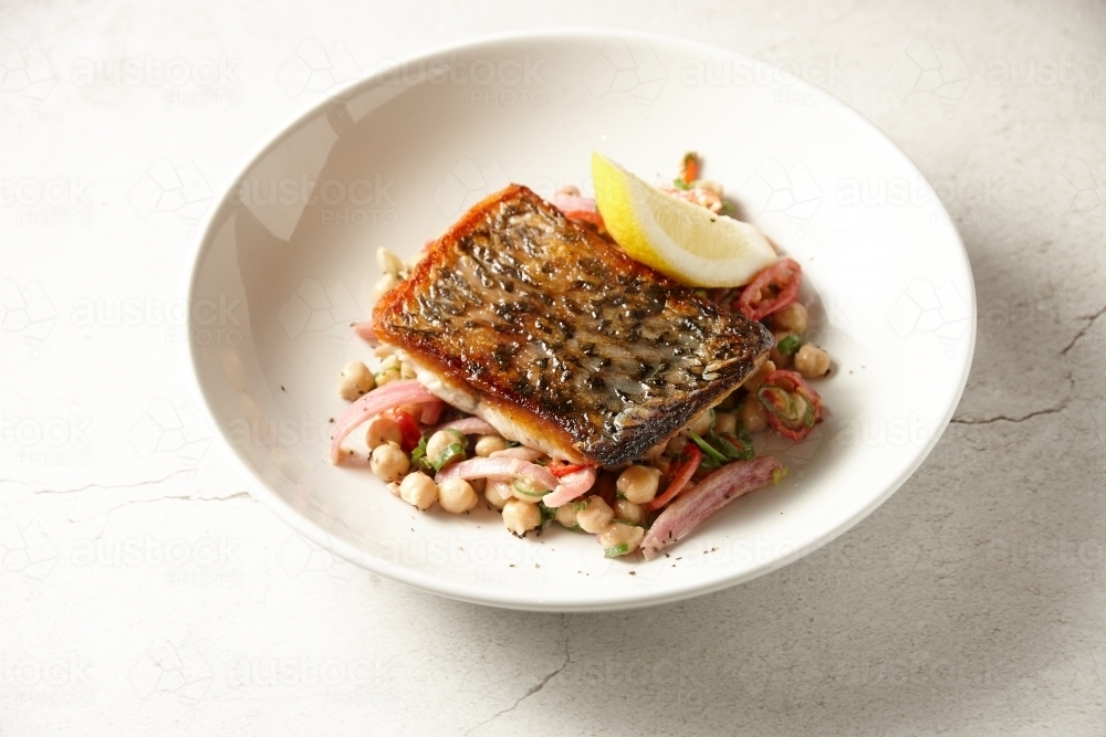 Crispy skin Barramundi with chick pea salad - Australian Stock Image