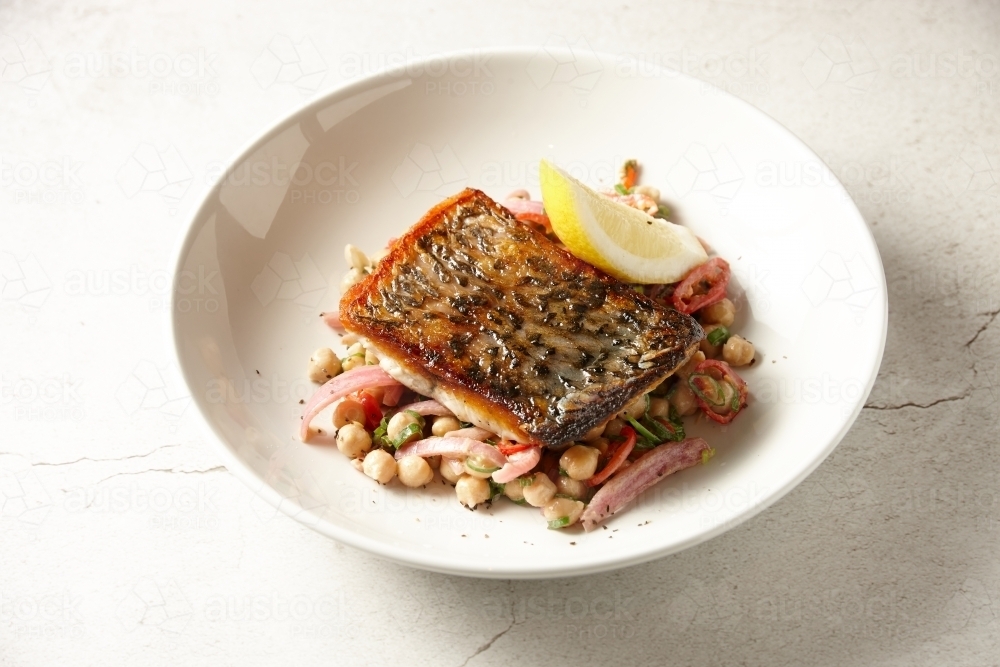 Crispy skin Barramundi with chick pea salad - Australian Stock Image