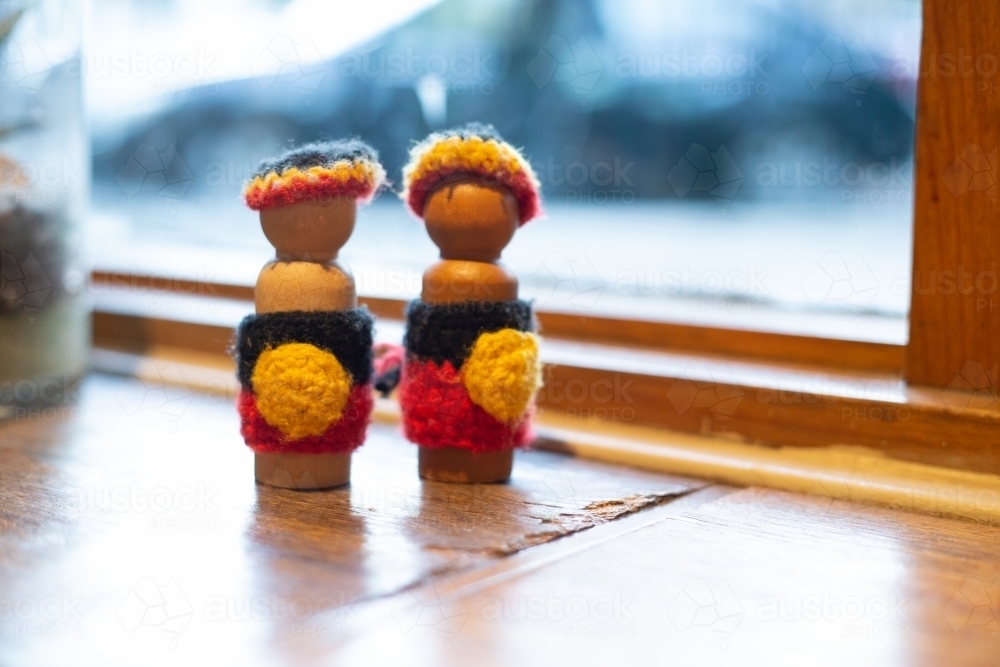 Crocheted craft dolls in Aboriginal flag colours - Australian Stock Image