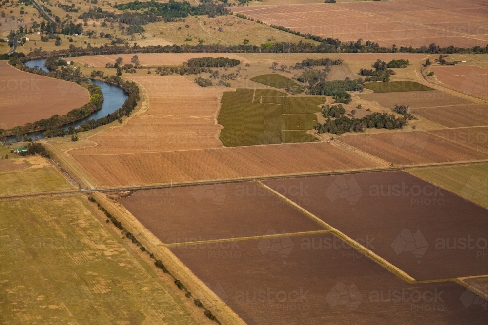 Crop paddocks and ploughed farmland seen from aerial perspective - Australian Stock Image