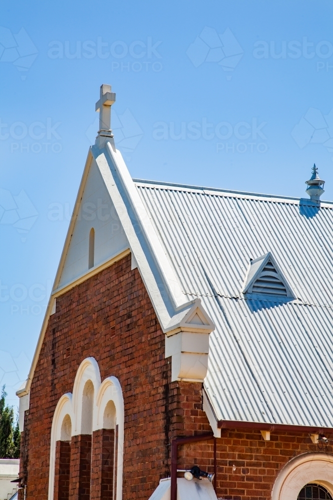 Crosses on the roof of a sunlit country church - Australian Stock Image