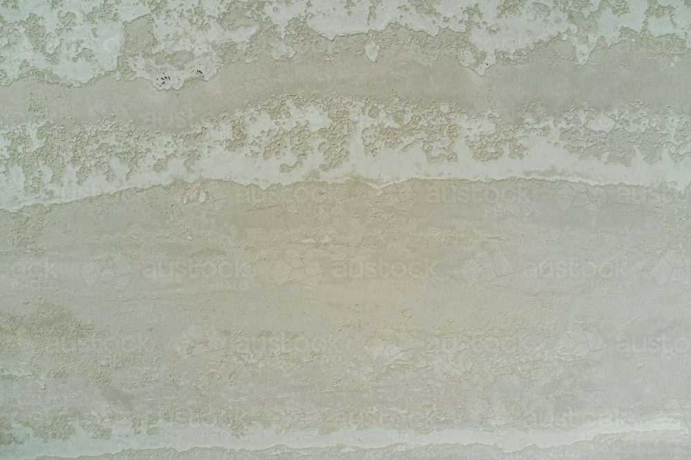 Crusty textures on the surface on a dry salt lake in Western Australia. - Australian Stock Image