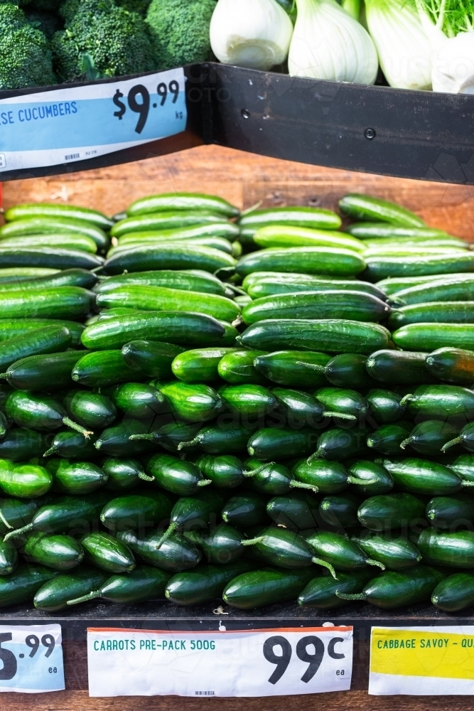 Image of cucumbers on display in a supermarket - Austockphoto