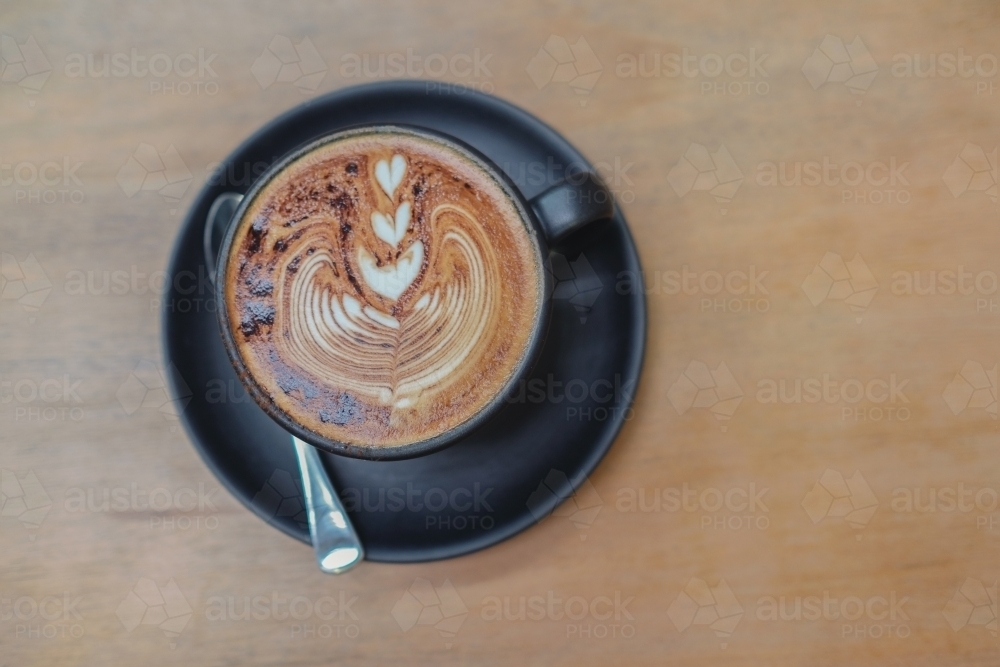 Cup of coffee cappuccino art - Australian Stock Image