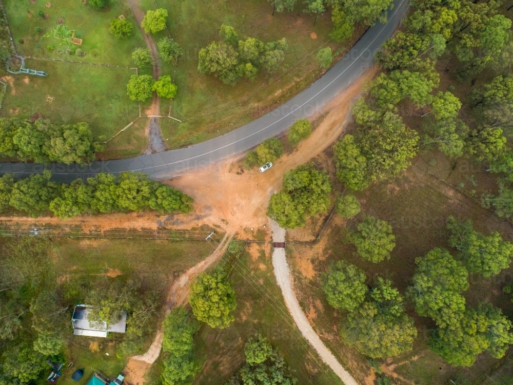 Curve of rural road and driveways from overhead view - Australian Stock Image