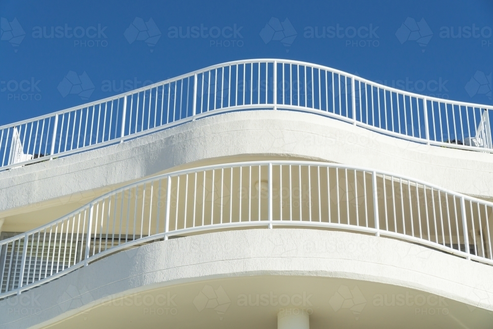 Curved railings on the upper balconies of a building - Australian Stock Image