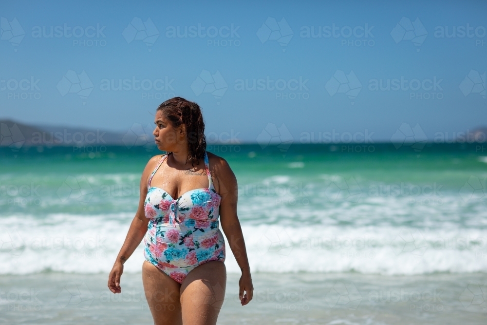 curvy woman in swimsuit on the beach - Australian Stock Image