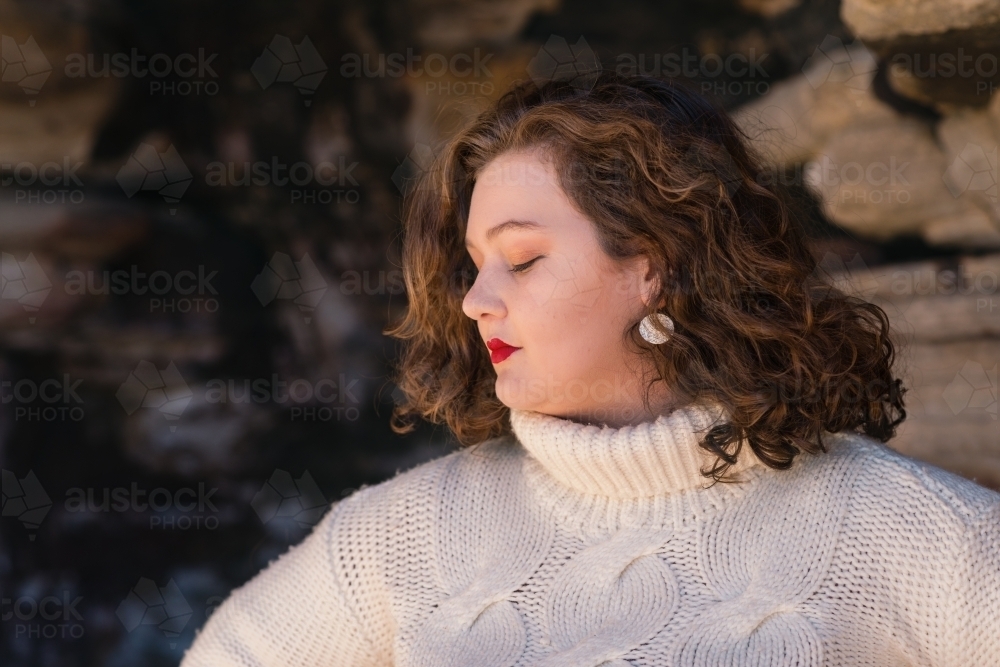 curvy woman wearing white sweater - Australian Stock Image