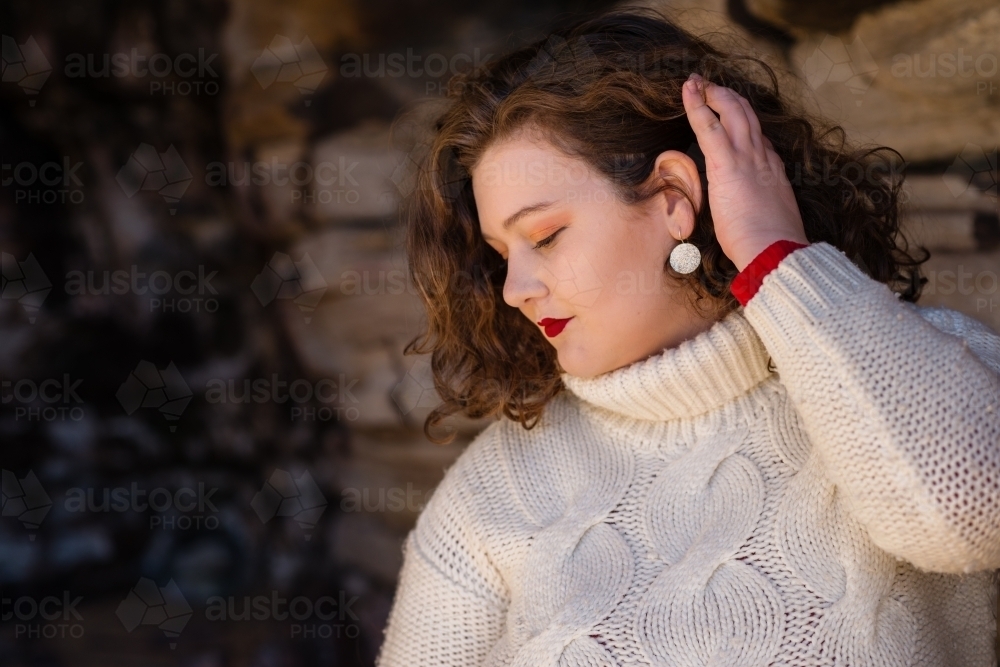 curvy woman wearing white sweater - Australian Stock Image