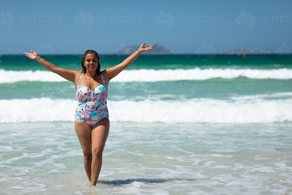 curvy young woman celebrating life in swimsuit at the beach - Australian Stock Image