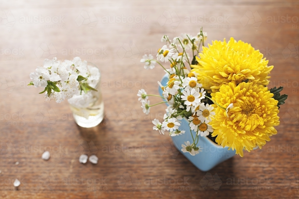 Cute bunches of flowers on table top in spring - Australian Stock Image