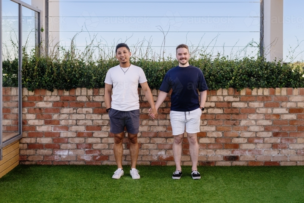 Cute gay couple holding hands - Australian Stock Image