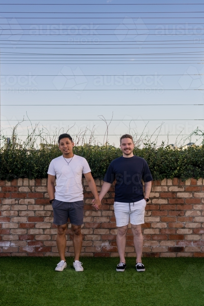 Cute gay couple holding hands - Australian Stock Image