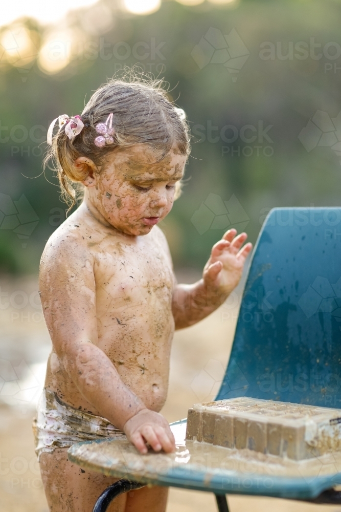 unde young little girls Image of Cute little girl playing in mud - Austockphoto