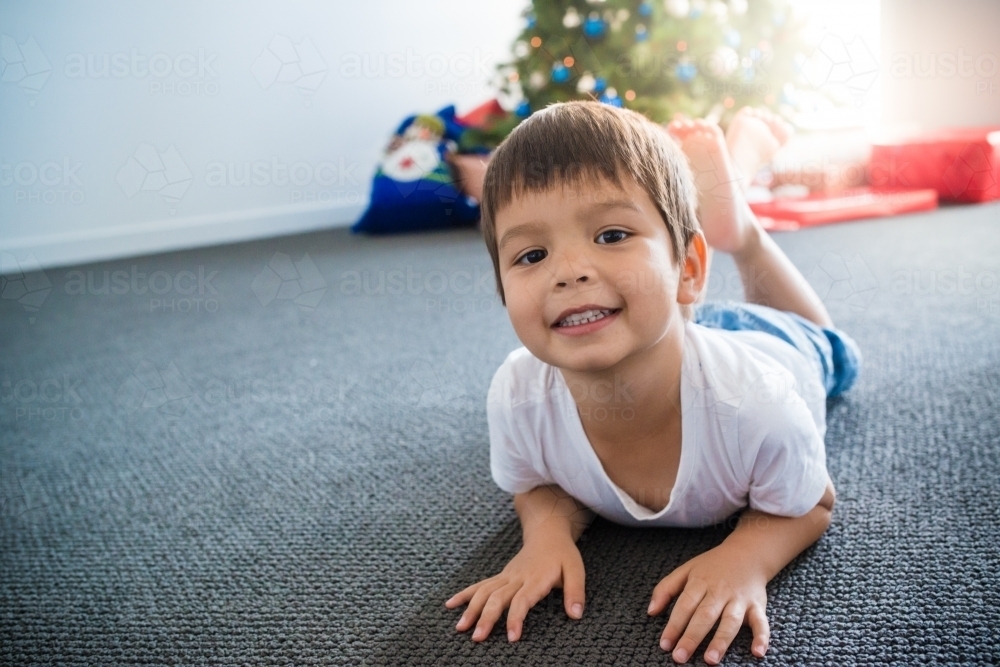 Cute mixed race 4 year old boy waiting for Christmas - Australian Stock Image