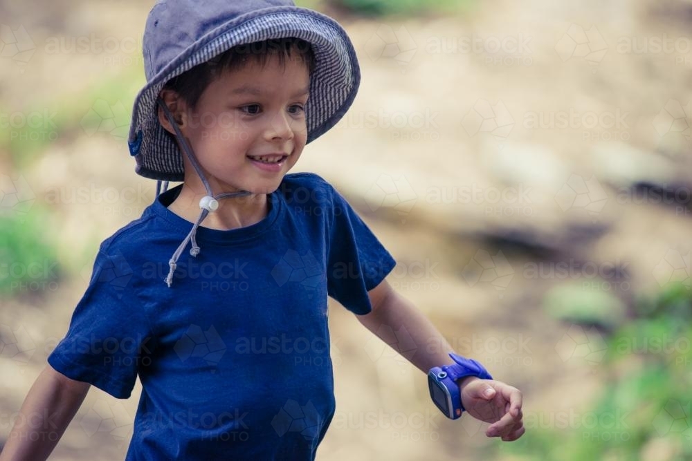 Cute mixed race little boy bushwalking on the Warrumbungles National Park Nature Trail - Australian Stock Image